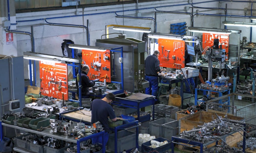 The FACAR workshop floor, steering units being stripped down at the benches